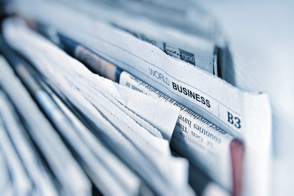 Picture of business section in a newspaper to showcase media coverage.
