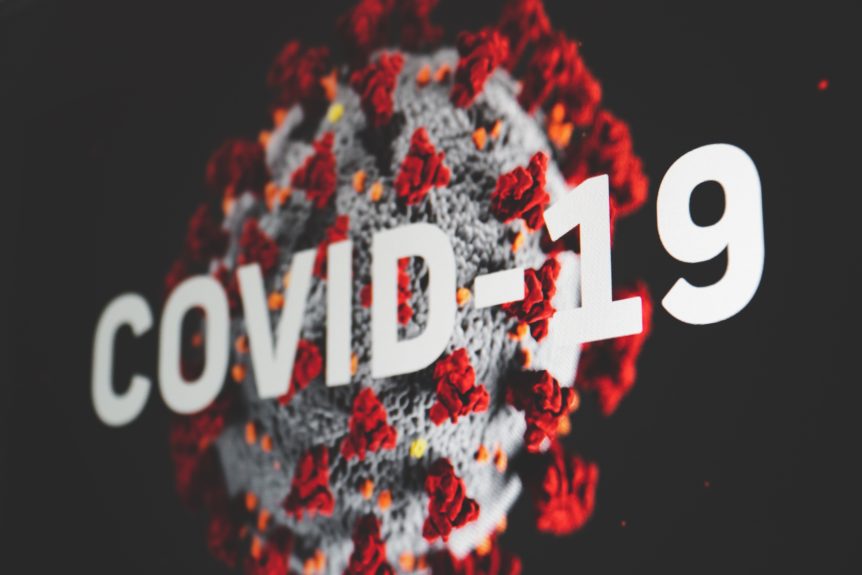 A virus cell with the words, 'Covid 19'